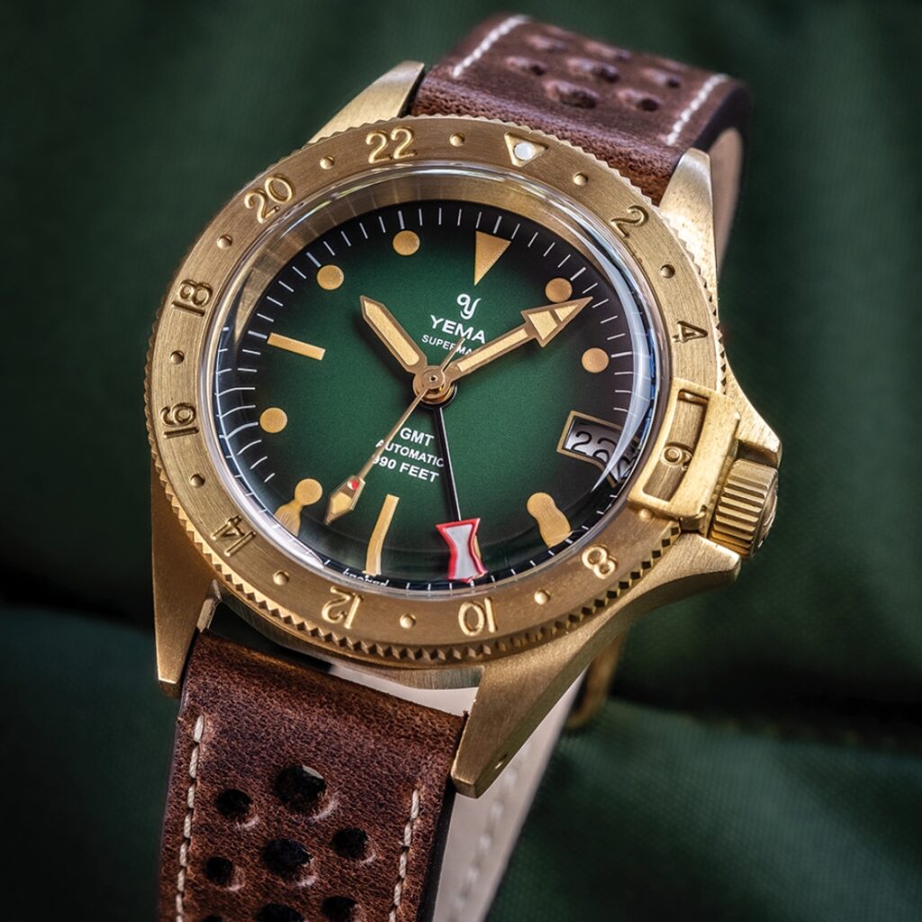 Image of the YEMA Superman GMT Bronze 39mm, a classic GMT watch with a 39mm bronze case, matte black dial, and unidirectional rotating bezel. The watch features luminous hands and indices for enhanced legibility.